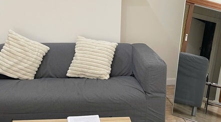 Plush gray sofa with pillows in cozy lounge at Mira Lash, Parafield Gardens, South Australia, AU.