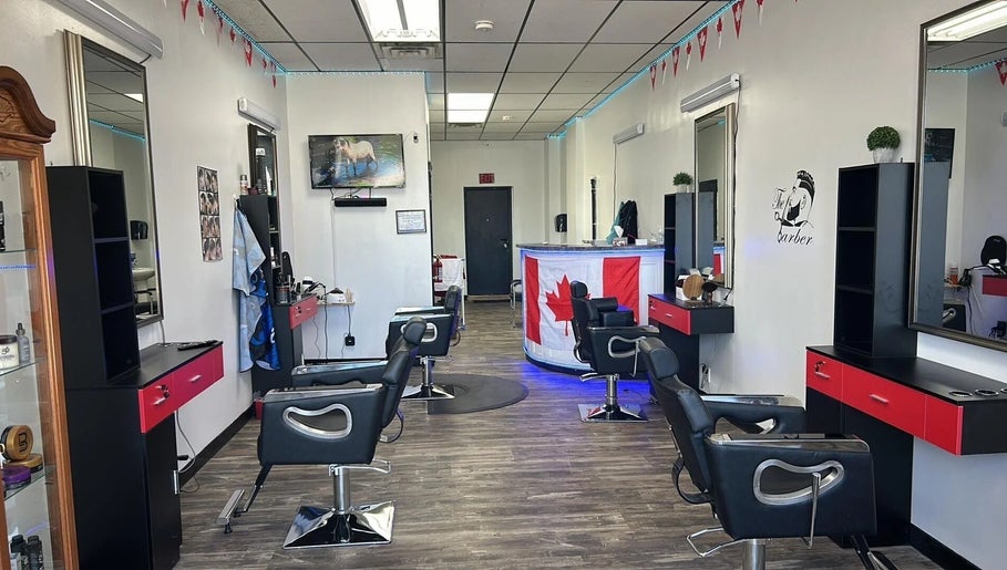 Interior of Kawartha Barbershop in Peterborough, Ontario, CA, showcasing modern styling stations and decor.