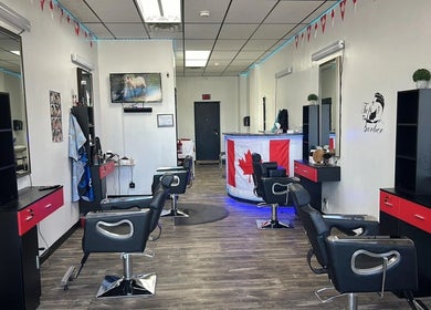 Interior of Kawartha Barbershop in Peterborough, Ontario, CA, showcasing modern styling stations and decor.
