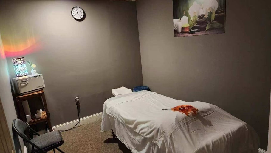 Tranquil massage room at Immanuel Acupressure Nature Spa, Rockville, Maryland, US with a plush table and decor.