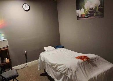 Tranquil massage room at Immanuel Acupressure Nature Spa, Rockville, Maryland, US with a plush table and decor.