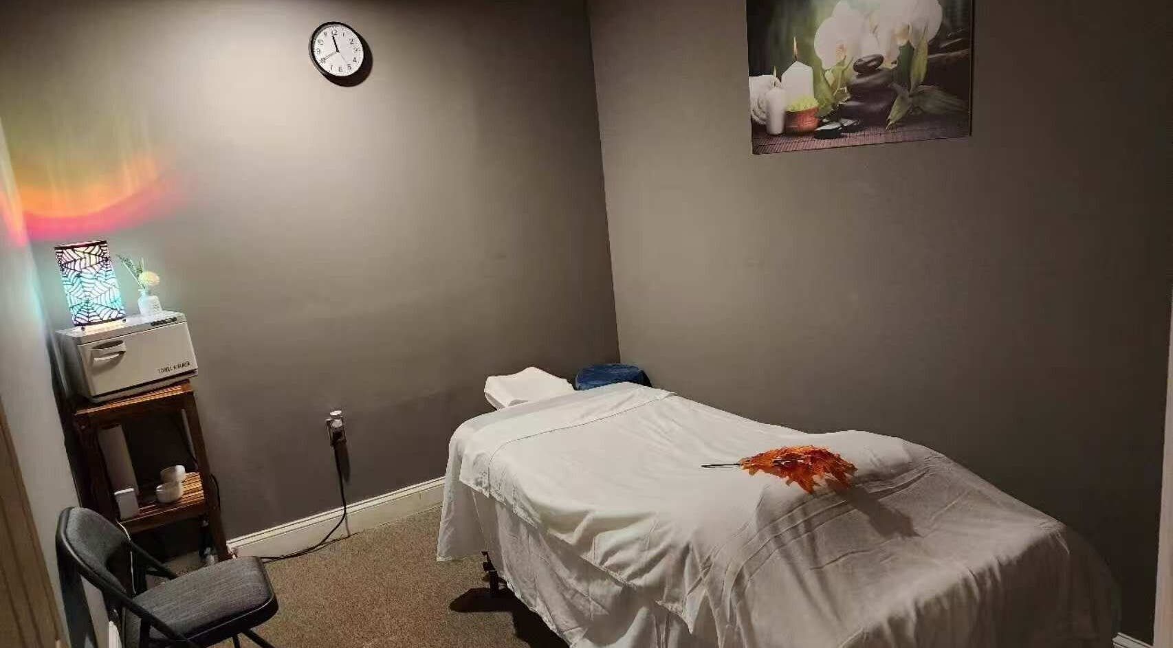 Tranquil massage room at Immanuel Acupressure Nature Spa, Rockville, Maryland, US with a plush table and decor.