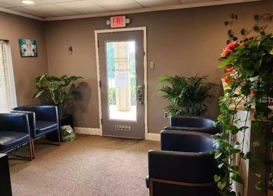 Cozy lobby of Immanuel Acupressure Nature Spa in Rockville, Maryland, US with lush greenery and seating.