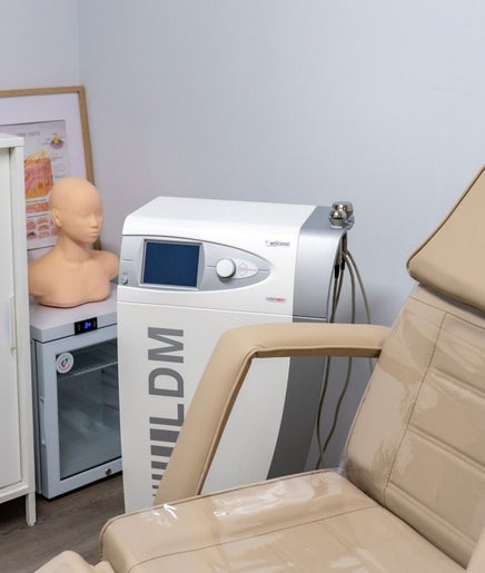 Treatment room at Nudia Skin Clinic, Melbourne, Victoria, AU with a beige chair and aesthetic equipment.