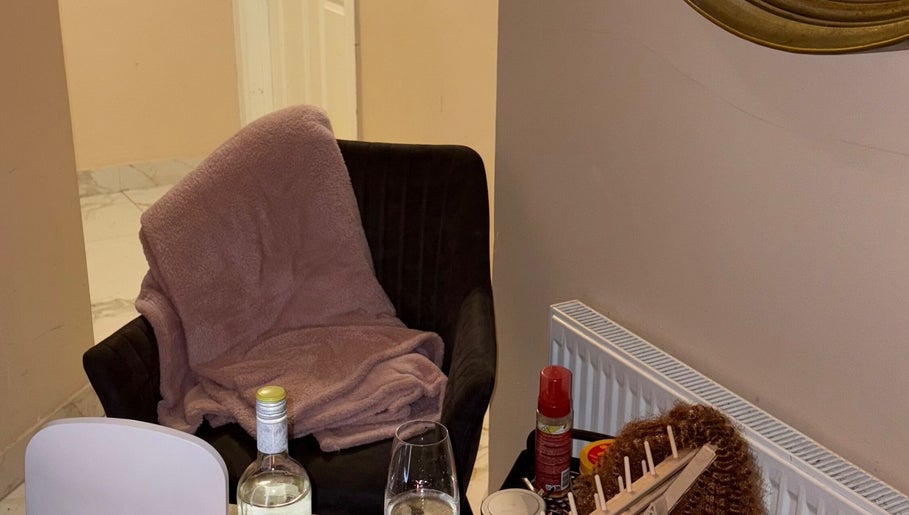 Cozy corner at HBN, County Longford, IE, with a blanket draped chair and wine glasses.