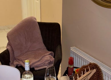 Cozy corner at HBN, County Longford, IE, with a blanket draped chair and wine glasses.