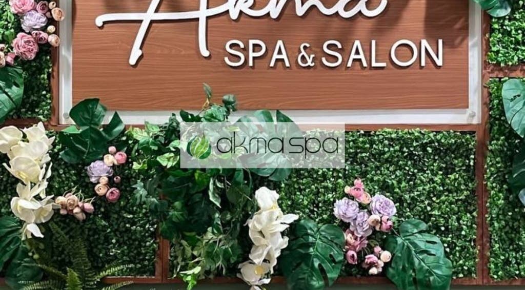 Entrance signage of Akma Spa Sungai Buloh in Shah Alam, Selangor, MY, adorned with green foliage and flowers.