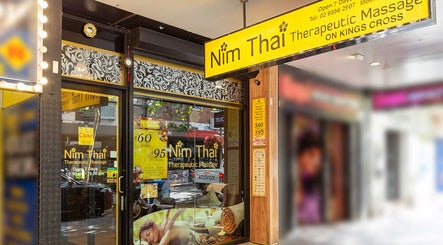 Entrance of NIM THAI Therapeutic Massage in Potts Point, New South Wales, AU, showcasing the vibrant signage.