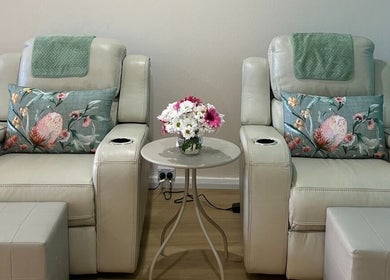 Relaxing massage chairs at TARA Thai & Remedial Massage, Darlinghurst, New South Wales, AU adorned with floral pillows.