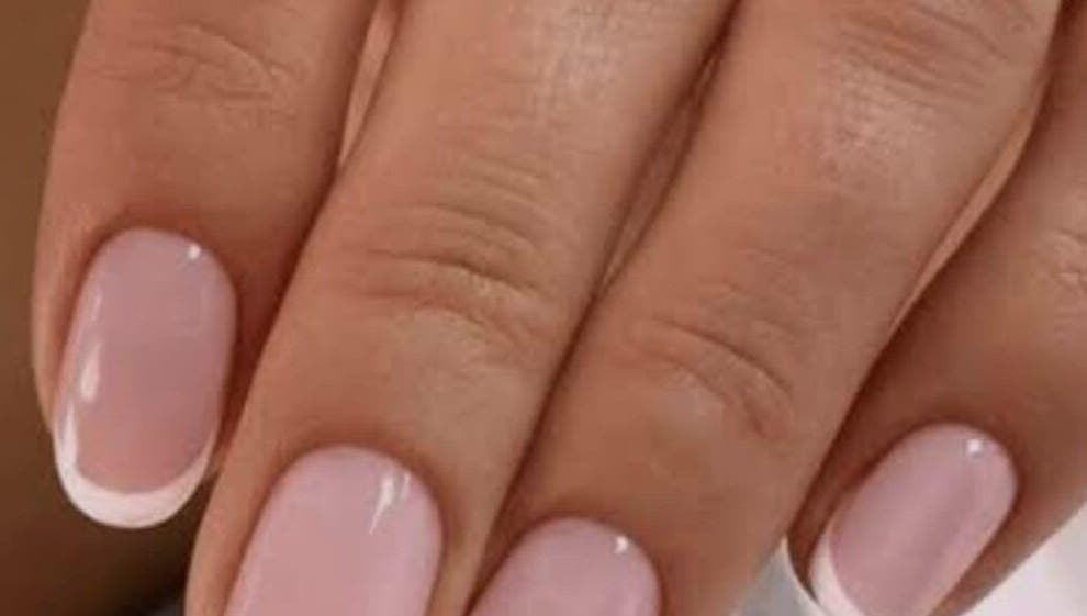 Close-up of elegant French manicure at Sanjula Bagdas Beauty Salon, Dubai, AE.