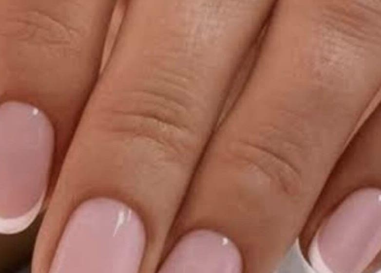 Close-up of elegant French manicure at Sanjula Bagdas Beauty Salon, Dubai, AE.