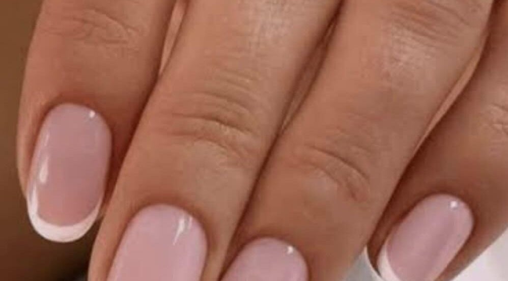 Close-up of elegant French manicure at Sanjula Bagdas Beauty Salon, Dubai, AE.