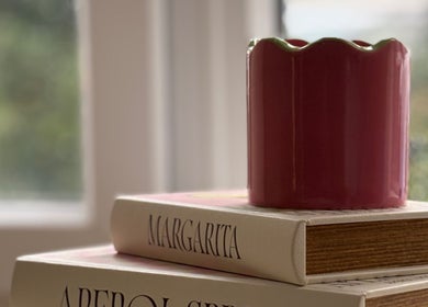 Stylish red vase sits on books at The Ladies Room, Lytham Saint Annes, England, GB.