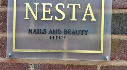 Nesta Nails and Beauty sign at Dudley, England, GB, featuring gold and black lettering.