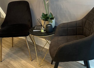 Comfortable seating area at Nesta, Dudley, England, GB, featuring stylish chairs and a modern table with decor.