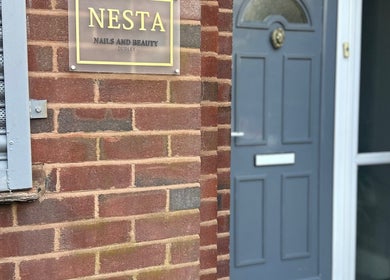 Nesta entrance with a sign, located in Dudley, England, GB. Showcasing a modern blue door.