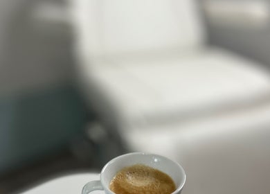 Cup of coffee on a table near a treatment chair at Nesta, Dudley, England, GB.