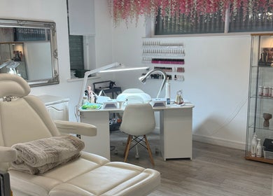 Nesta's beauty room in Dudley, England features luxurious seating and a modern manicure station.