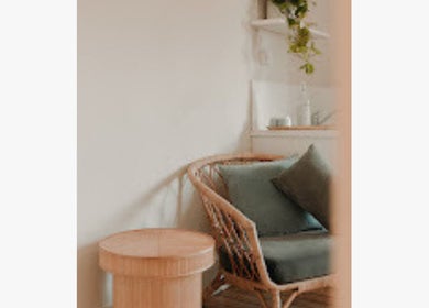 Cozy seating area at Inbodybondi, Sydney, New South Wales, AU with green cushions and wooden accents.