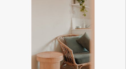 Cozy seating area at Inbodybondi, Sydney, New South Wales, AU with green cushions and wooden accents.