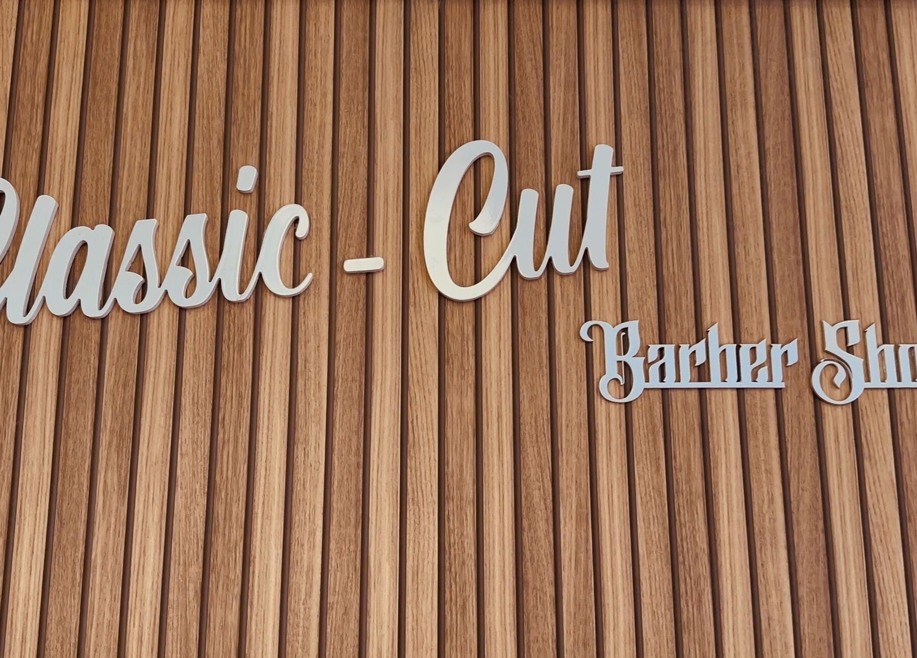 Enseigne de Classic-Cut barber shop à Saint-louis, Saint-pierre, RE sur fond en bois sophistiqué.