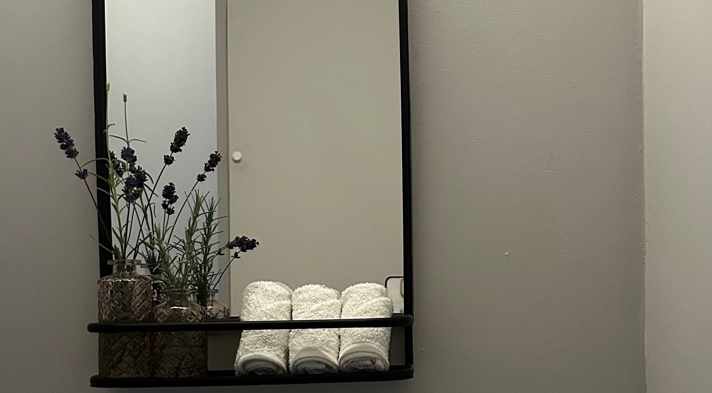 Lavender and towels on shelf at Sureechai Massages, Hove, Vlaanderen, BE, reflecting a tranquil ambiance.