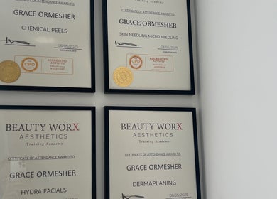 Certification wall at Skinsbyygrace, Liverpool, England, GB showcasing beauty and wellness expertise.