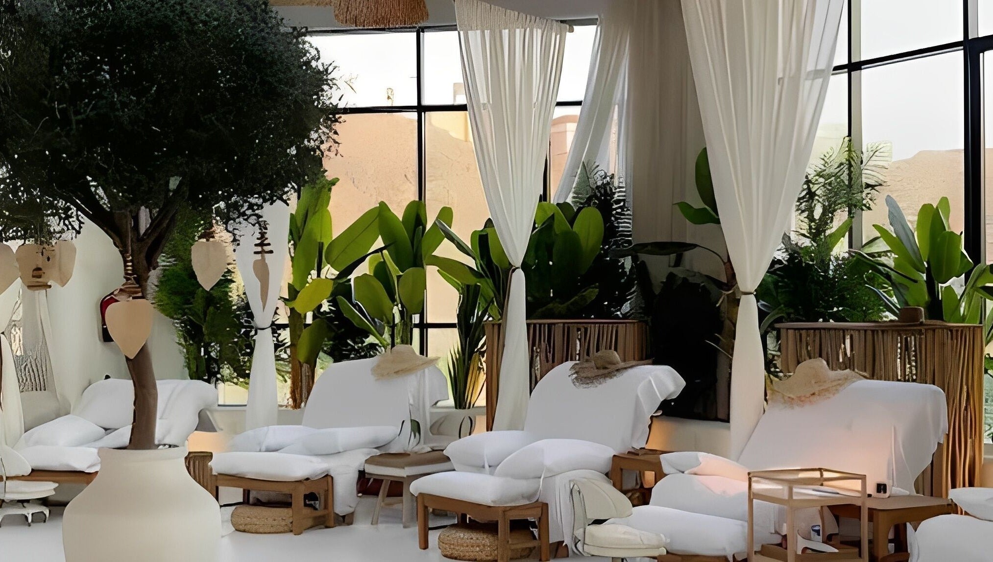 Relaxing lounge area at De Palma Nail Spa, Makkah, Makkah Province, SA, with lush plants and cozy seating.
