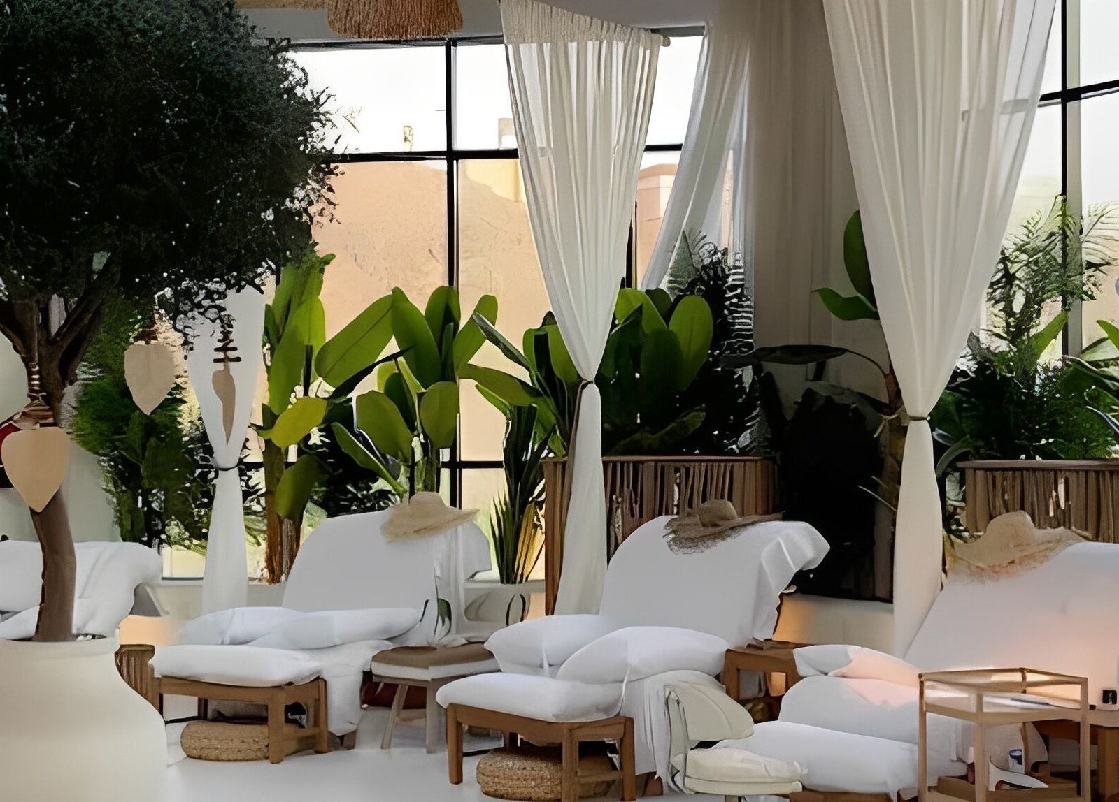 Relaxing lounge area at De Palma Nail Spa, Makkah, Makkah Province, SA, with lush plants and cozy seating.