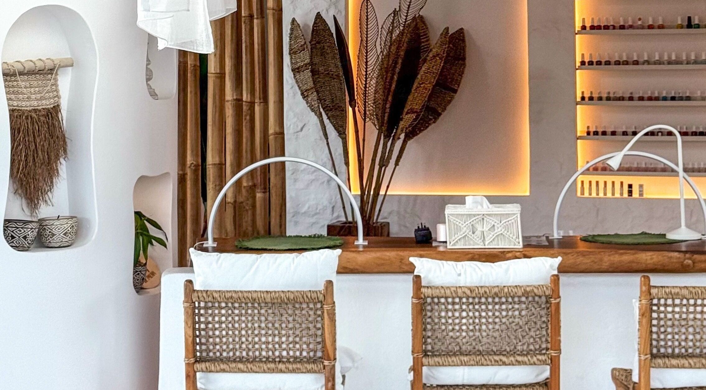 Elegant nail salon at De Palma Nail Spa in Makkah, Makkah Province, SA with wicker chairs and ambient lighting.