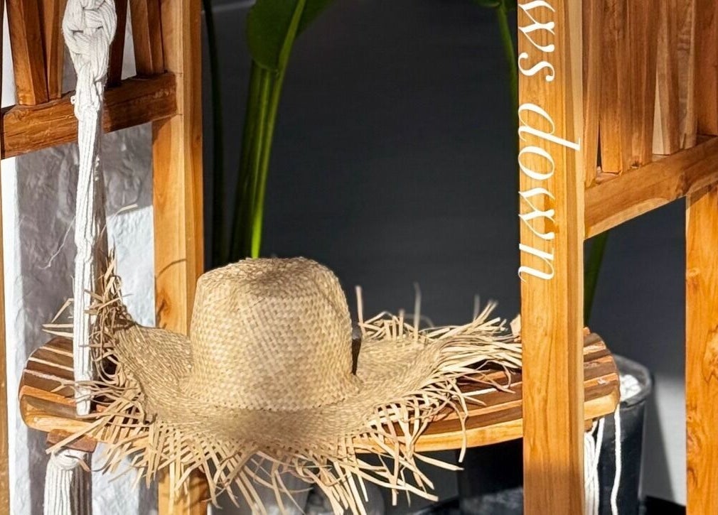 Straw hat on rustic wooden stand at De Palma Nail Spa, Makkah, Makkah Province, SA.
