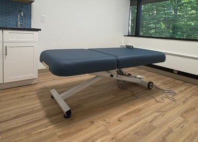 Elegant massage table in Xiomara Wellness Massage, Avon, Connecticut, US, offering a tranquil relaxation space.