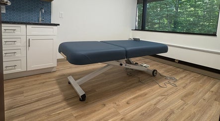 Elegant massage table in Xiomara Wellness Massage, Avon, Connecticut, US, offering a tranquil relaxation space.