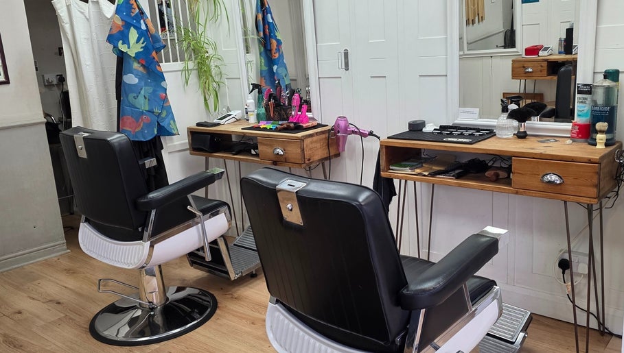 Elegant barber setup at Ruth - Clippers Barber Shop, Daventry, England, GB featuring stylish chairs and equipment.