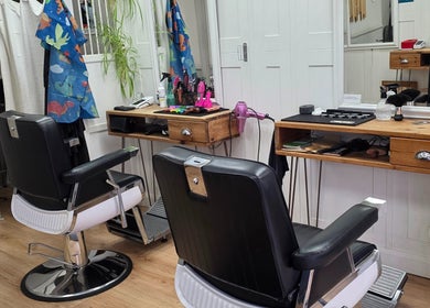Elegant barber setup at Ruth - Clippers Barber Shop, Daventry, England, GB featuring stylish chairs and equipment.
