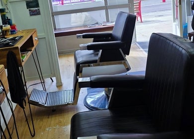 Interior view of Ruth - Clippers Barber Shop in Daventry, England, GB, showcasing classic black barber chairs.