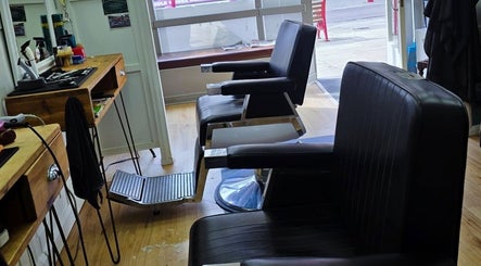 Interior view of Ruth - Clippers Barber Shop in Daventry, England, GB, showcasing classic black barber chairs.