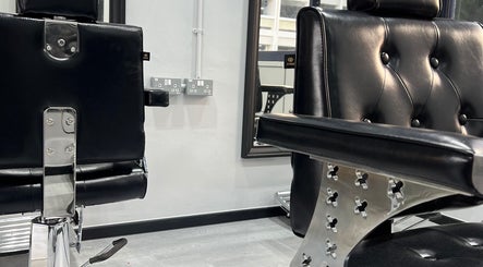 Stylish black barber chairs at TL Hair Studio Sg, Singapore, SG, showcasing modern salon design.