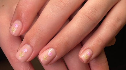 Close-up of floral nail art at Mabci, Glasgow, Scotland, GB, showcasing intricate pink flower designs.
