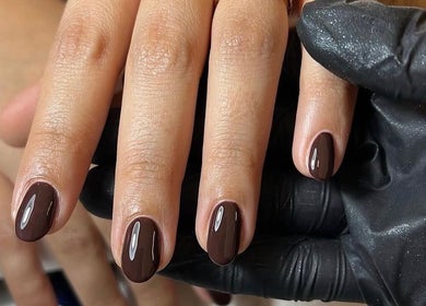 Polished nails with dark gloss at Mabci, Glasgow, Scotland, GB for a chic, stylish look.