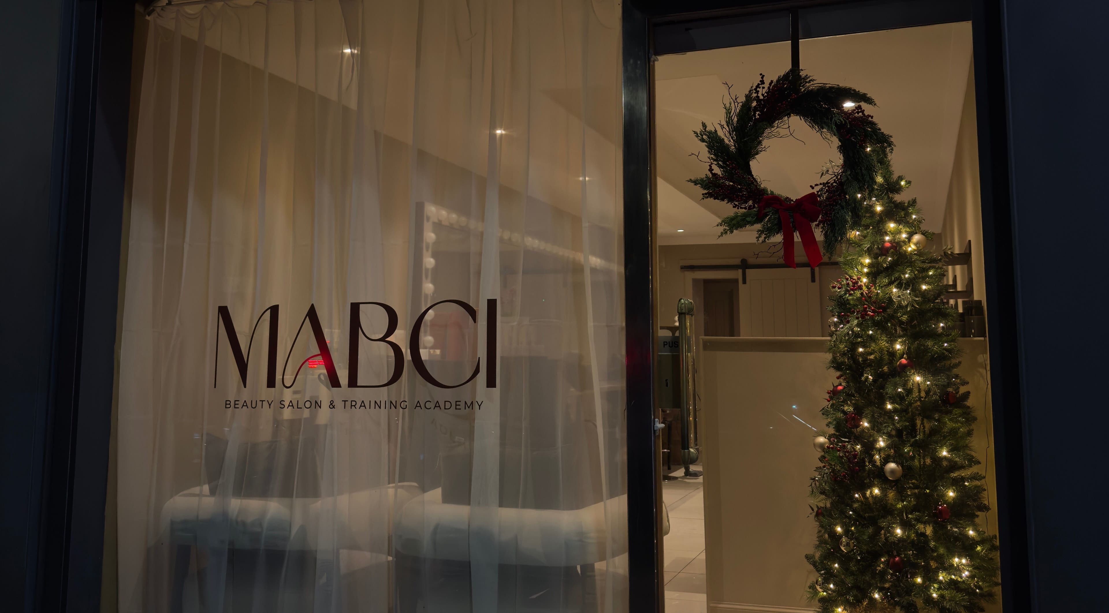 Mabci salon in Glasgow, Scotland, GB with festive decor and a glowing Christmas tree.