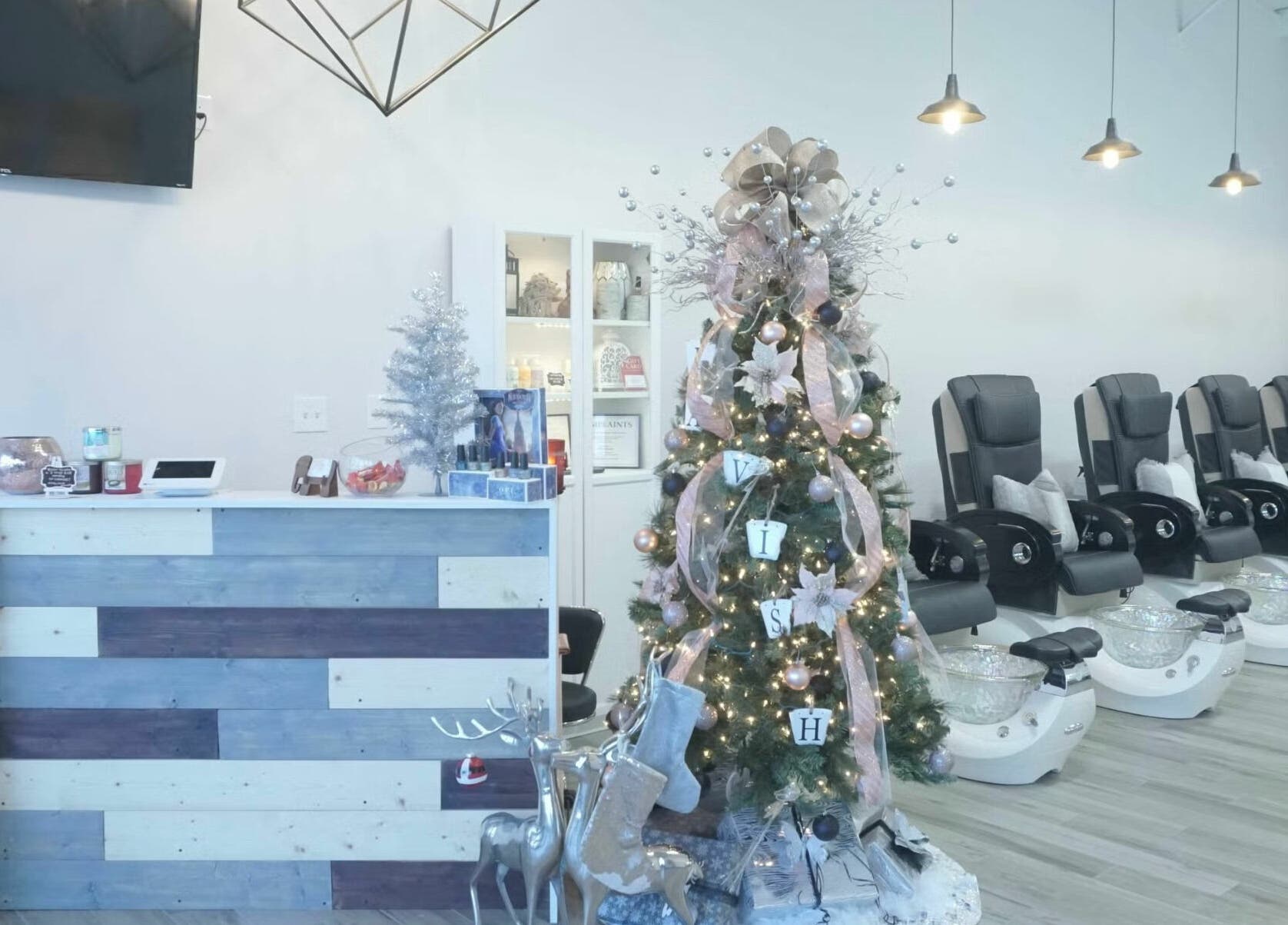 Festive nail salon at Lavish Nails, Conroe, Texas, US with Christmas decor and pedicure chairs.