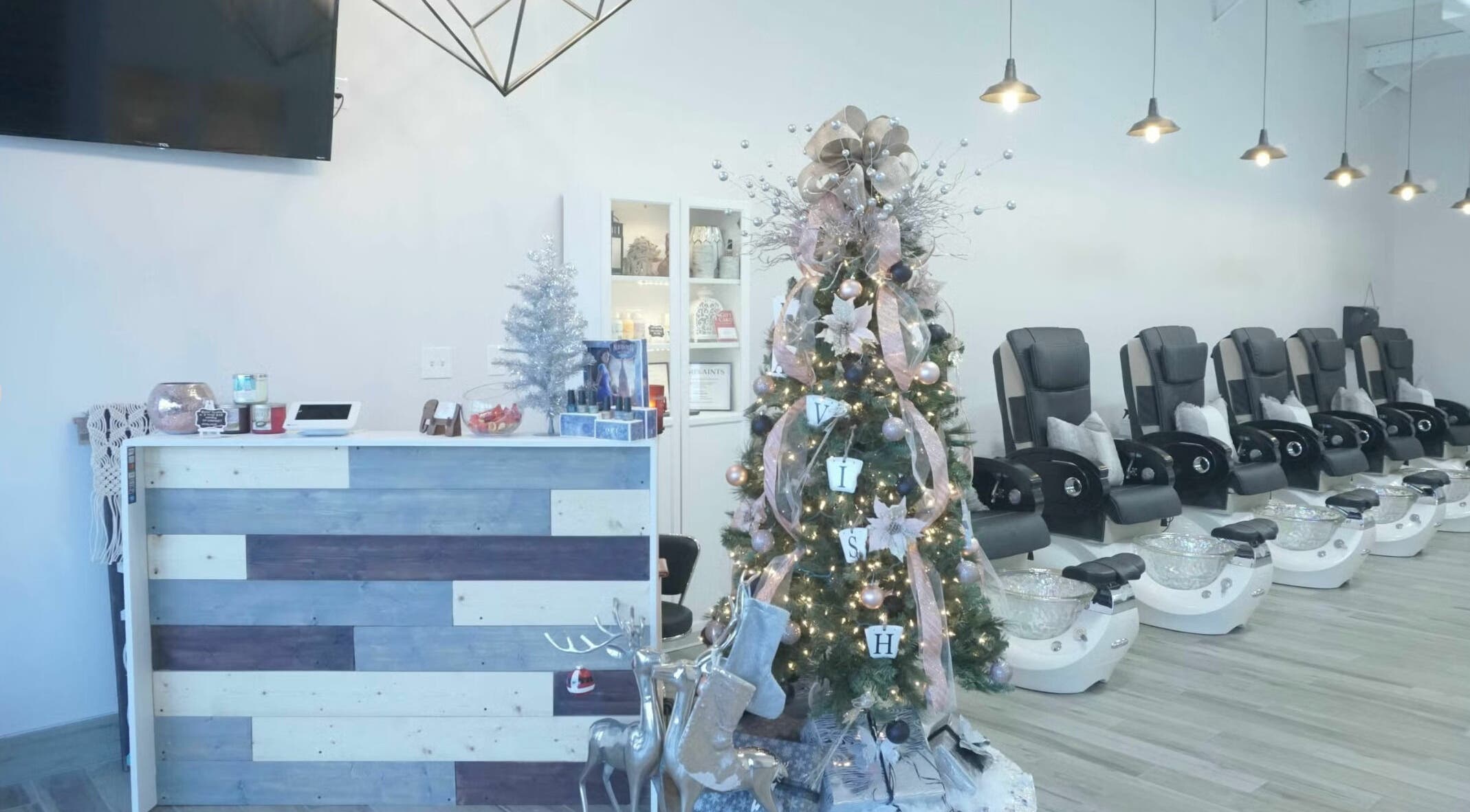 Festive nail salon at Lavish Nails, Conroe, Texas, US with Christmas decor and pedicure chairs.