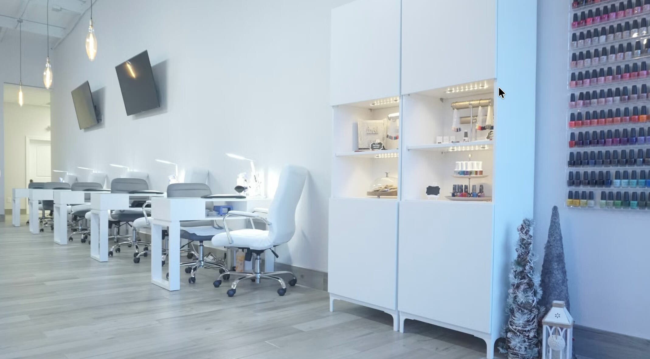 Elegant interior of Lavish Nails, Conroe, Texas, US with manicure stations and colorful nail polish display.