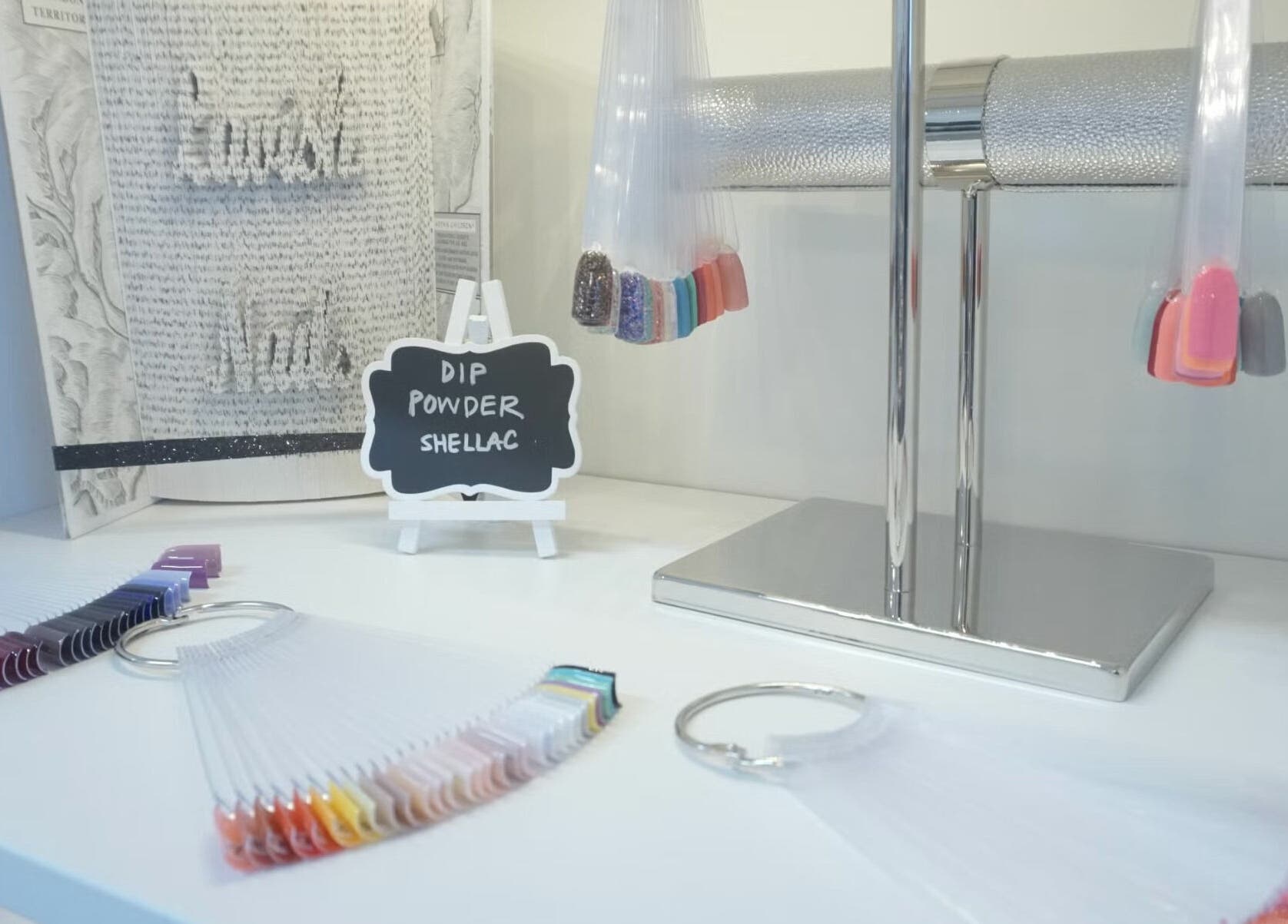 Nail polish display at Lavish Nails in Conroe, Texas, US featuring dip powder and shellac options.
