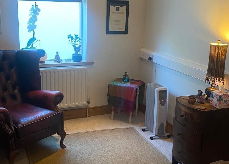 Cozy therapy room at Marcela Bonturi in Malahide, County Dublin, IE with a plush chair and warm lighting.