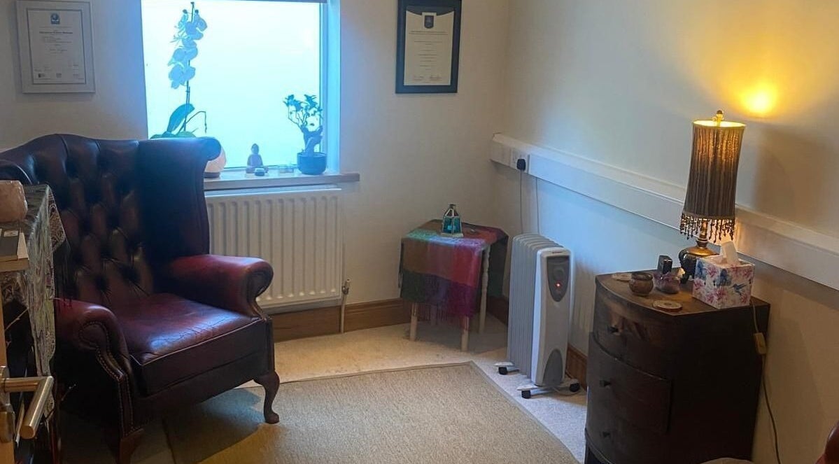 Cozy therapy room at Marcela Bonturi in Malahide, County Dublin, IE with a plush chair and warm lighting.