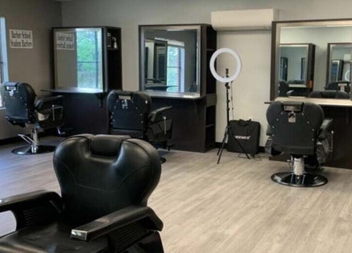 Modern salon interior at Quality Braids By Grace (AR) in Little Rock, Arkansas, US, featuring stylish chairs and mirrors.
