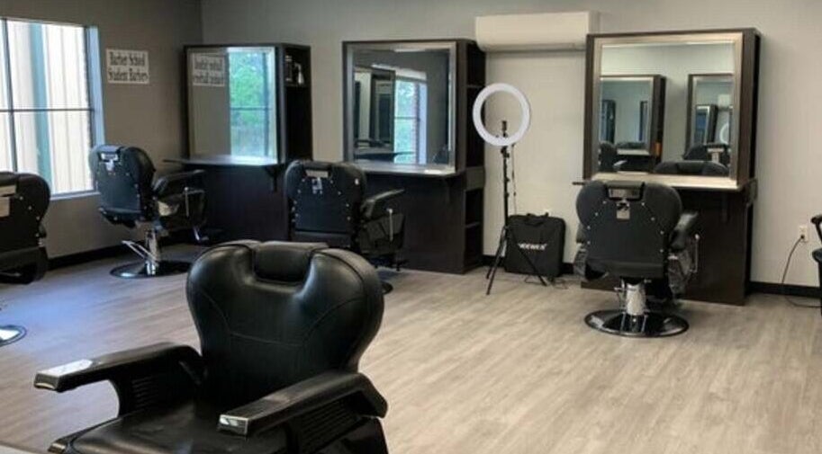 Modern salon interior at Quality Braids By Grace (AR) in Little Rock, Arkansas, US, featuring stylish chairs and mirrors.