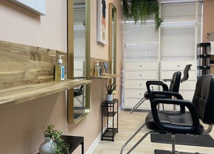 Stylish interior of Quality Braids By Grace (AR) in Little Rock, Arkansas, US with modern chairs and decor.